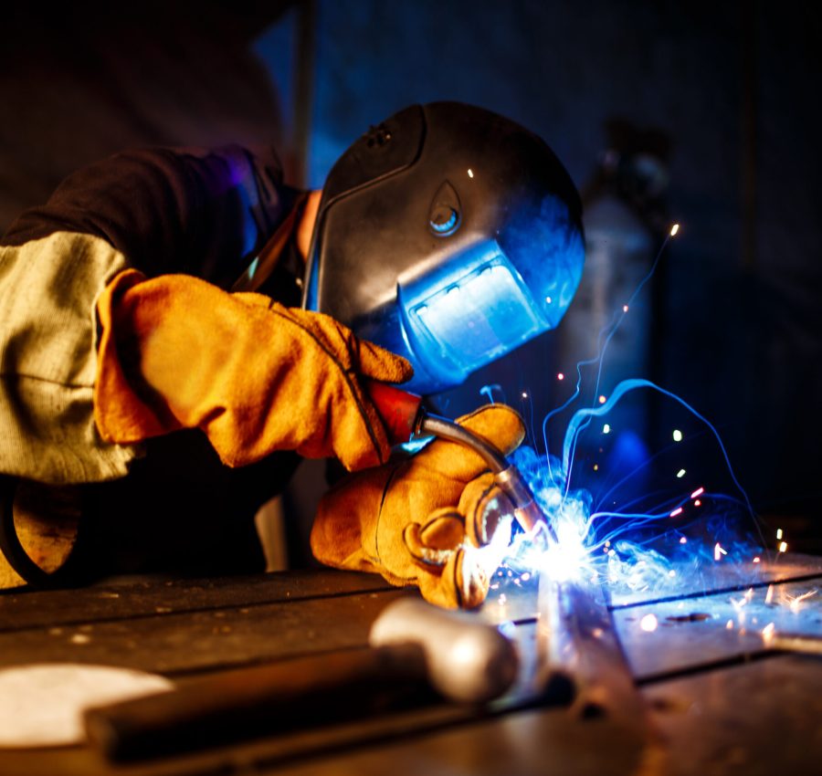 Worker cutting metal with plasma equipment. on plant